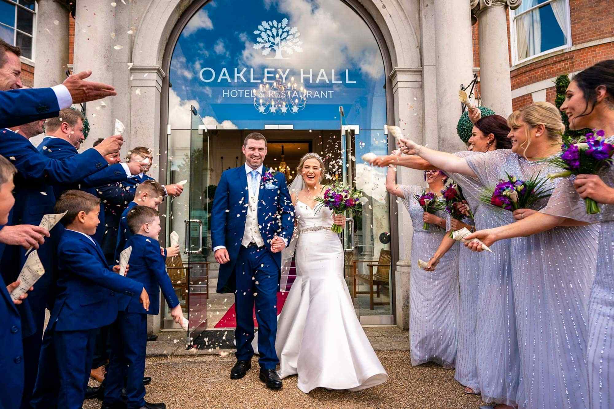 Oakley Hall Wedding Photographers | Tansley Photography Confetti Shot outside the venue