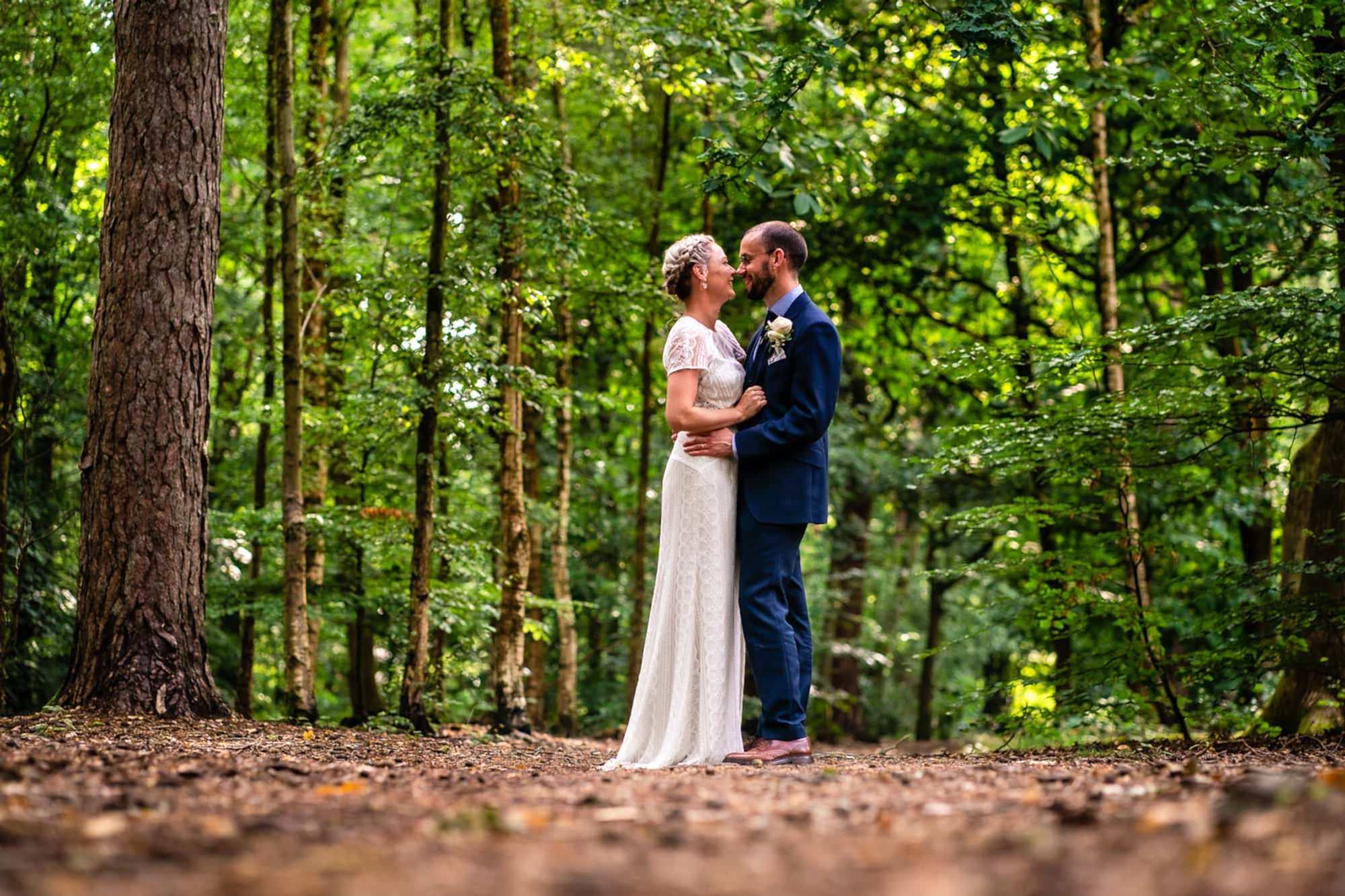 Headley Village Hall Wedding Photographer - Portrait of wedding couple in forest at Arford Common