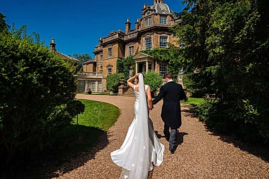 Wedding Couple walking towards Hampton Court House